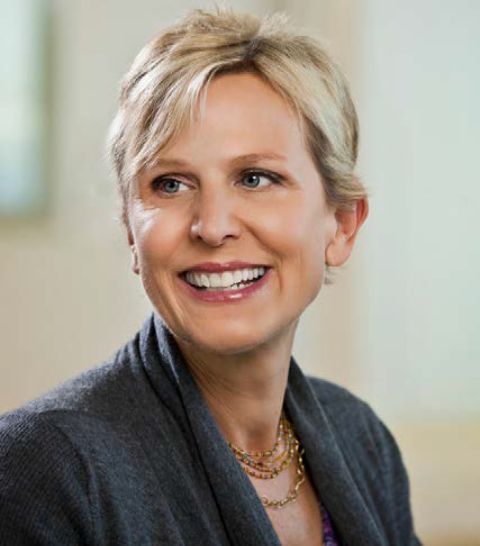 Amy smiling as a pose in photo